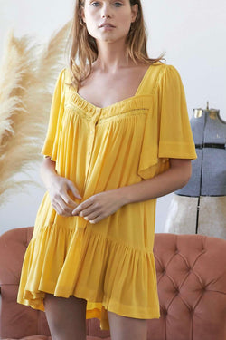 Yellow| rayon| babydoll| dress| with| pockets| and| front| button| detail|